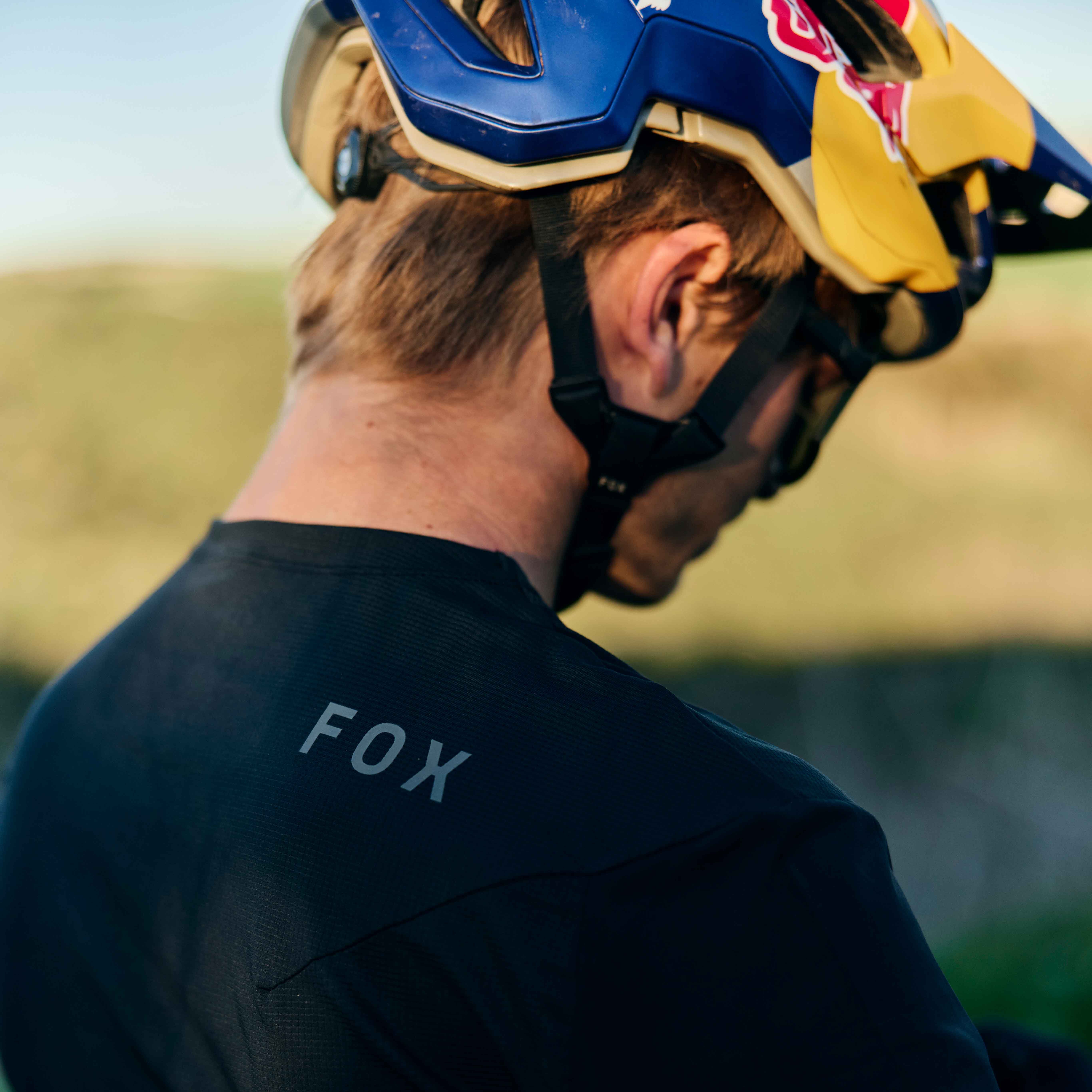 close up of man in flexair gear wearing a red bull helmet
